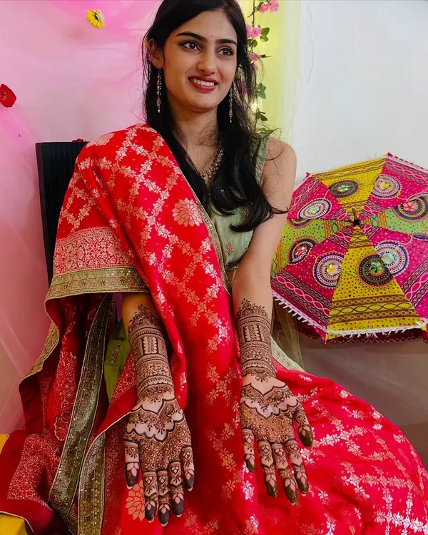 A radiant bride-to-be proudly showing her full bridal mehendi. Her happiness is what makes my work so fulfilling.