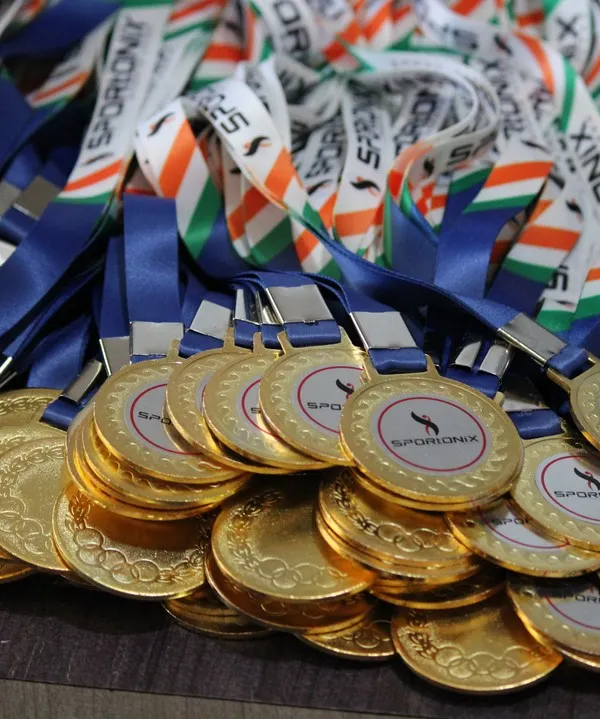 A close-up of the gleaming gold medals ready to be awarded to the champions of our Anniversary Cup. We handle all the details.
