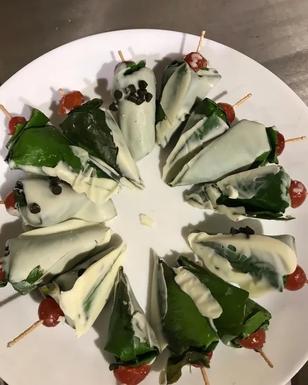 A creative fusion dessert that always surprises and delights guests. This is my chocolate-dipped paan, garnished with a cherry. It’s a perfect example of how I blend traditional Indian flavours with contemporary presentation for a unique catering experience.