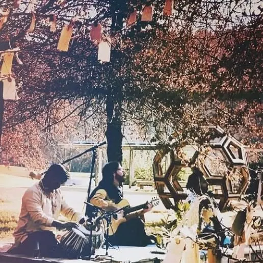 A moment from an outdoor fusion concert, playing alongside a guitarist under a decorated tree. This performance blended Indian percussion with Western acoustic sounds in a natural, artistic setting.