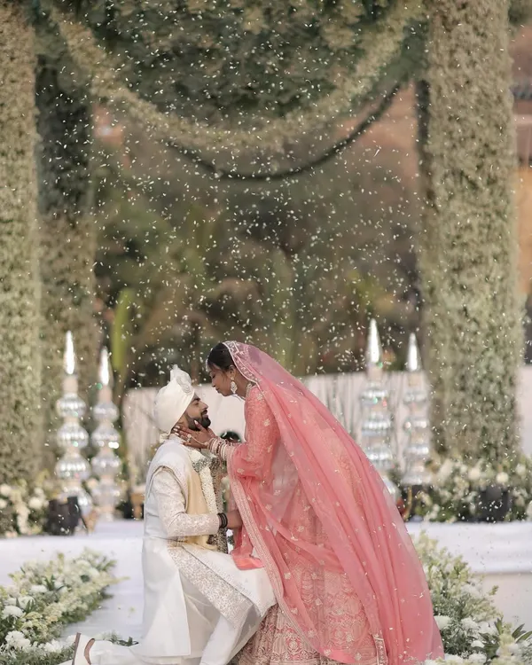 A truly magical varmala ceremony, where the couple is showered in petals under a canopy of lush white baby's breath. I designed this moment to feel like a scene from a dream, focusing on elegant floral decor and creating an unforgettable memory.