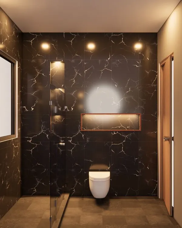 A 3D render for a bathroom in GK-1, South Delhi. The design uses large-format black marble tiles with white veins to create a dramatic and luxurious feel, enhanced by warm accent lighting in the shower niche.