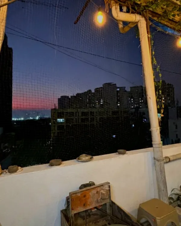 Welcome to my rooftop studio in Malad. This is the view that greets you during our evening workshops, a beautiful sunset over the city. It's the perfect, calming backdrop for getting creative.