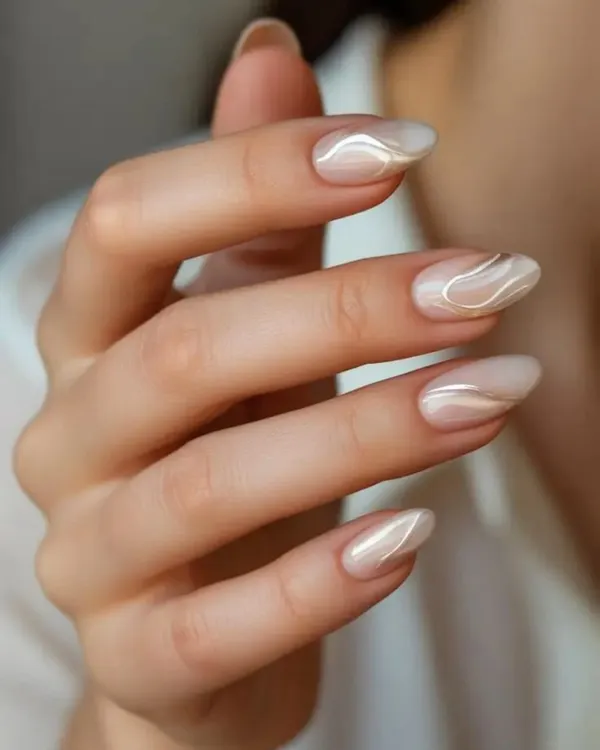 This elegant design, which I call 'Cloud Dancer', features soft, pearlescent swirls on a neutral base. It's a sophisticated and trendy nail art choice that complements any look.