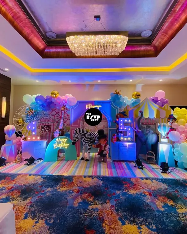 This is how I do carnival themes. A full-scale, immersive setup with a giant ferris wheel, custom backdrops, and vibrant lighting to create a truly magical atmosphere for a 5th birthday.