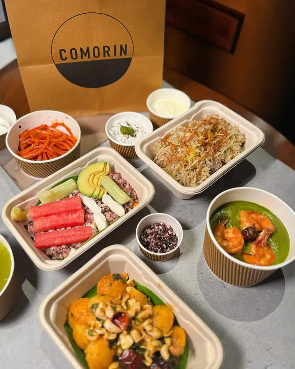 This is what a perfect night in looks like. A full spread of Comorin favorites, from hearty bowls to fresh salads and flavorful sides, all packed and ready to be plated your way.