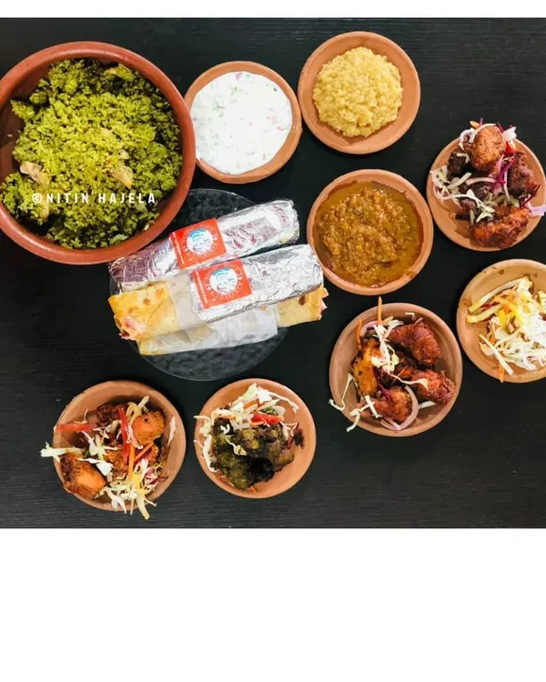 This is the full Babakull's experience, a spread that tells my family's story. You can see our signature Thuppangadi Biriyani, a variety of heritage kebabs like the B'luru Kebab and Torpedo Chilli Kebab, and our popular chicken ghee roast rolls. It's a feast rooted in pre-independence era recipes.