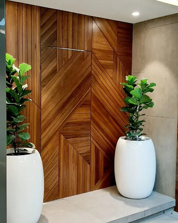 For this modern automation studio, I selected Fiddle Leaf Fig trees in sleek white planters. The vertical form of the plants enhances the height of the room and provides a natural counterpoint to the geometric wooden wall feature.