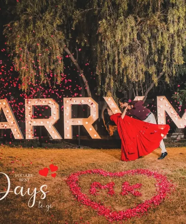 A grand proposal setup with marquee letters spelling "MARRY ME," used for a creative 10-day wedding countdown shoot.