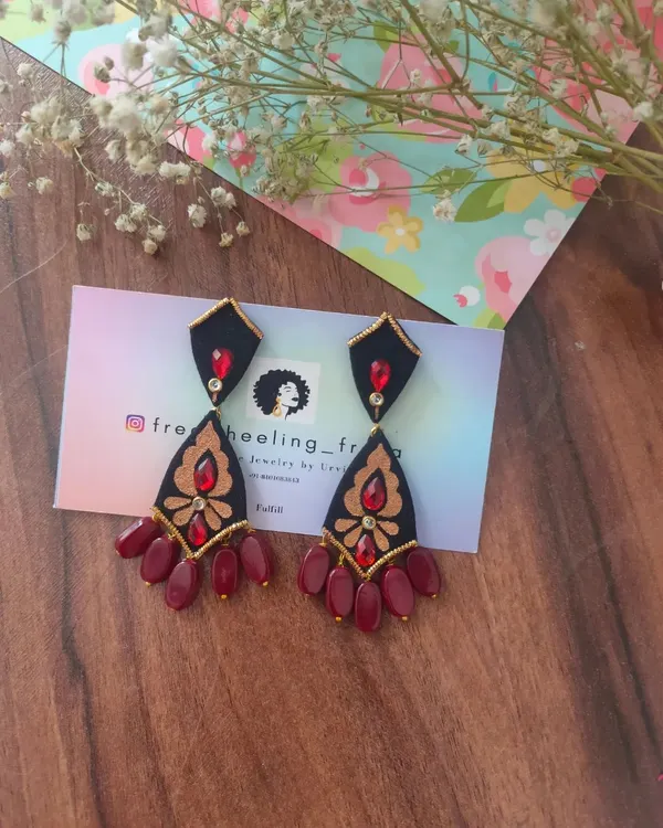 These hand-painted earrings are a dramatic and elegant choice. I've used a combination of black, red, and gold on a multi-tiered fabric base to create a piece that is perfect for weddings and special events.