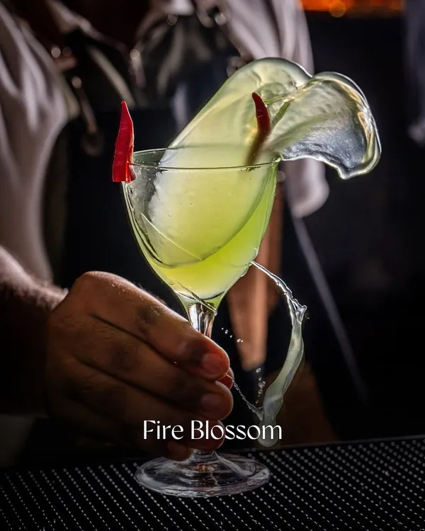 We capture the artistry in every detail. This action shot of a 'Fire Blossom' cocktail shows our expertise in using dramatic lighting and high-speed photography to create visuals that are both elegant and exciting, perfect for making a bar or restaurant menu stand out.