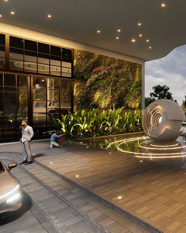 A close-up of the drop-off area at the RRBC entrance plaza, highlighting the vertical green wall and the base of the sculptural water feature. This view shows the careful integration of biophilic design and modern materials to create a sophisticated and welcoming atmosphere.