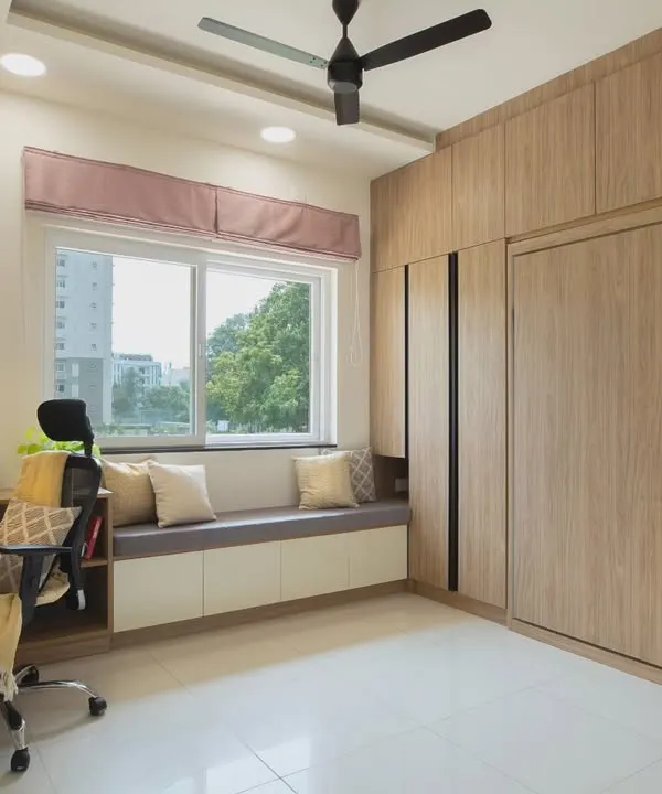 This guest room is designed to be a fully functional home office. The Murphy bed is completely concealed within the wooden cabinetry, providing a spacious work area without sacrificing the ability to host guests.