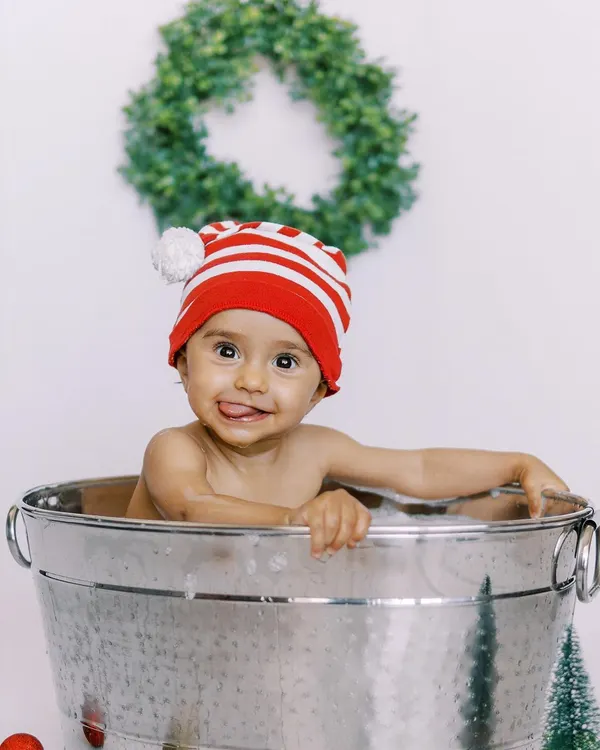 The pure, uninhibited joy of a splash session. This little one's cheeky grin and happy splashes make for an unforgettable photo.