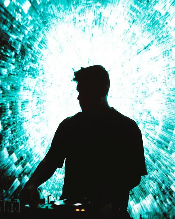 A powerful silhouette of me against a stunning, complex visual projection. This is the essence of my AV shows, where music and visuals become one.