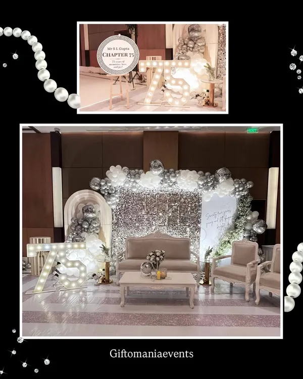 The main stage for a 75th birthday, designed with a silver glam theme. This setup includes a full sequin wall, an organic balloon arch, comfortable lounge seating for the guests of honor, and large light-up marquee numbers.