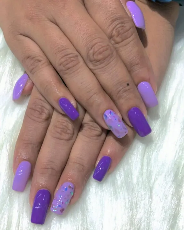 A fun and vibrant unicorn-inspired set using different shades of purple and a glitter accent nail.