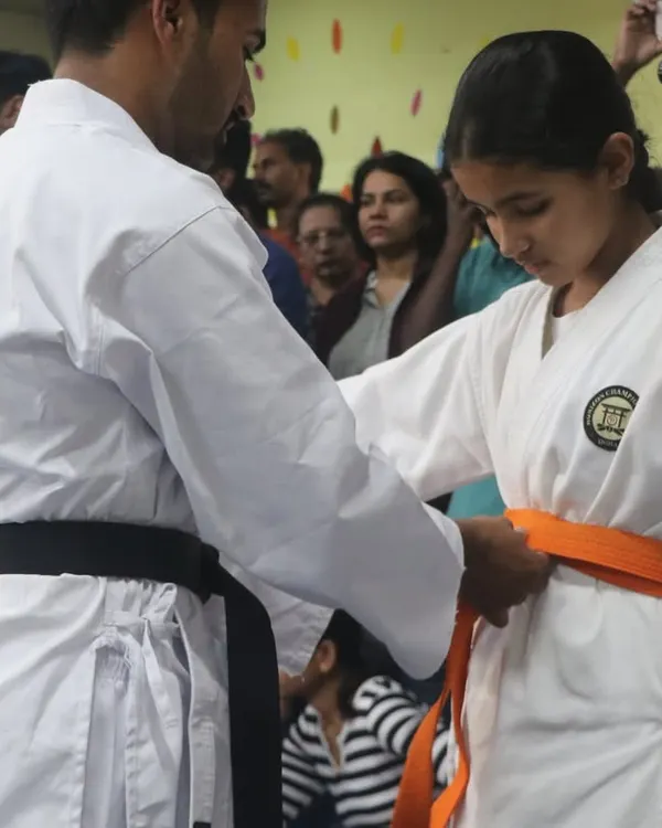 A significant moment for every student. Here, I am awarding a new belt, which is a symbol of their hard work, dedication, and progress on their karate journey.