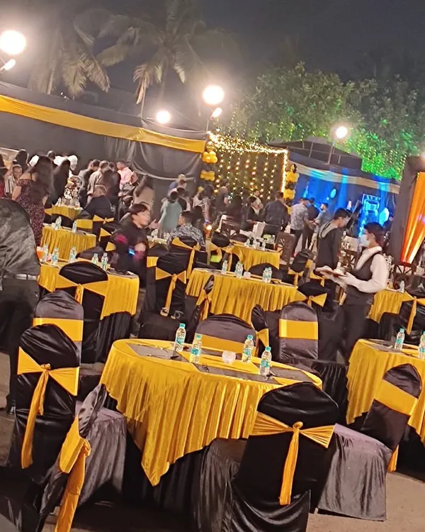 An elegant outdoor setup with black and yellow decor for the New Year's Eve bash we catered for the Indian Coast Guard.
