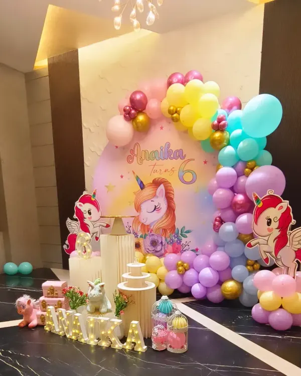 A truly magical unicorn-themed 6th birthday for Annika. We used a pastel balloon garland, custom unicorn cutouts, and elegant pedestal stands to create a whimsical and photo-ready party setup.