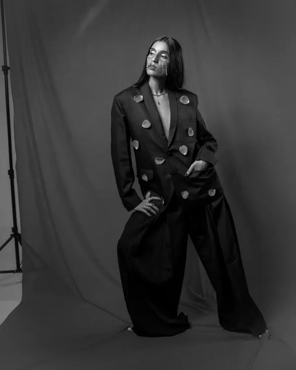 A black and white editorial shot exploring form and shadow. This image, captured in-studio, highlights the power of minimalist styling and strong composition in fashion photography.