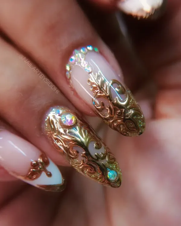 This is a close-up of one of my most detailed sets, featuring hand-sculpted 3D gold filigree over a classic French ombre base. I added iridescent rhinestones for a touch of sparkle, creating a truly luxurious and royal look.