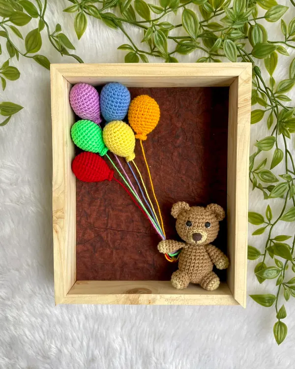 This is one of my favorite things to make. I handcraft this little teddy bear, give him a bunch of colorful balloons, and place him inside a beautiful wooden frame. It’s a piece of 3D art that brings so much warmth and personality to a nursery wall.
