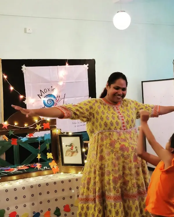 The pure joy of connection! A child reaches out during an interactive part of our story session. We encourage movement and participation to make learning active and fun.