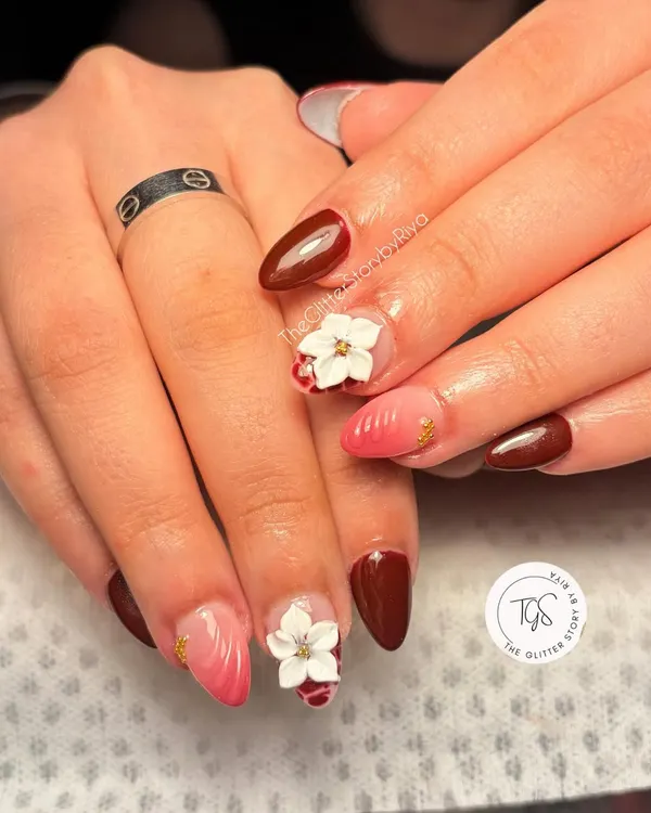 A beautiful bridal set combining deep maroon, a soft pink ombré, and intricate white 3D flowers. The small gold studs add a touch of traditional elegance.