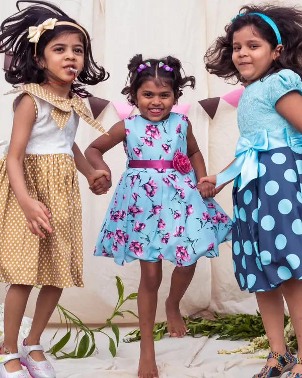 A trio of friends, a trio of styles. I designed these coordinating dresses in polka dots and florals to create a beautiful, harmonious look for their group photos.