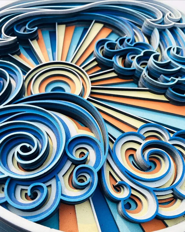 This is our multi-layered Sea Wave art, a vibrant and dynamic piece that captures the energy of the ocean. The intricate cuts and colorful layers create a stunning 3D effect, with swirling waves and a radiant sun that bring any wall to life.