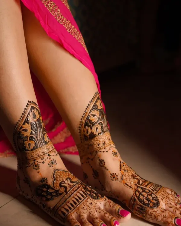 A close-up of a stunning peacock design for the feet. The way the pattern flows from the ankle to the toes is designed to elongate and adorn the feet beautifully.