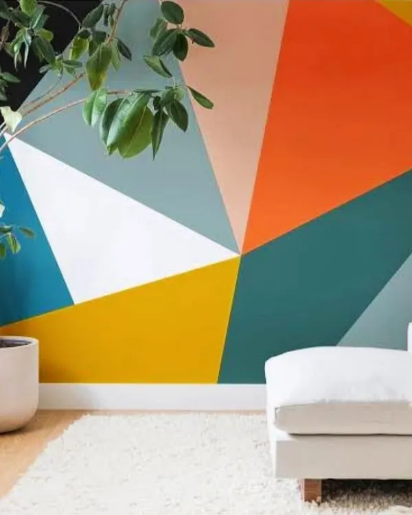 A bold, geometric accent wall featuring a vibrant color palette. This type of custom paint job is perfect for adding energy and a modern artistic touch to a living room or office.
