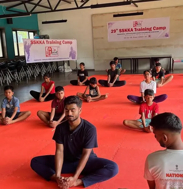 Meditation is a key part of our holistic training approach. Here, students at our 29th SSKKA Training Camp engage in a guided meditation session to calm their minds and improve focus before a day of intense martial arts practice.