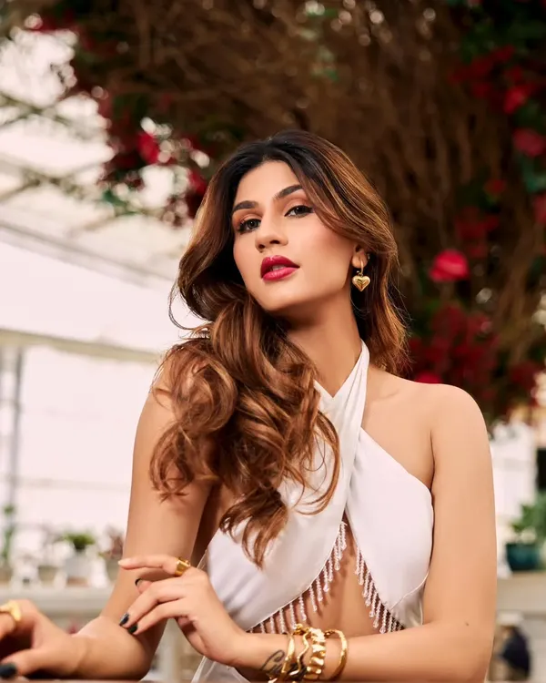 Creating a look of pure sophistication for Nidhi Tapadia. The bold, matte red lip is the star, balanced by clean eye makeup and beautifully sculpted, voluminous hair.