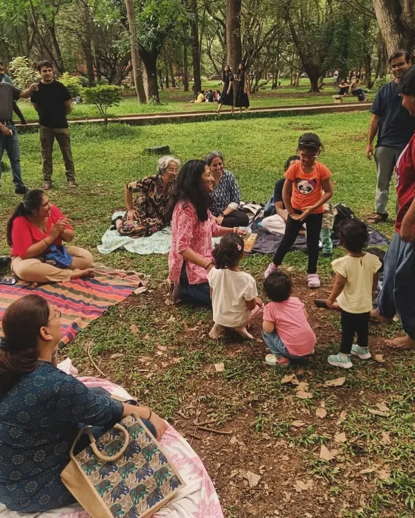 A candid moment from our Mother's Day session, with parents and children gathered on mats, completely engrossed in the story. This is the relaxed, community atmosphere we cherish at our outdoor storytelling workshops.