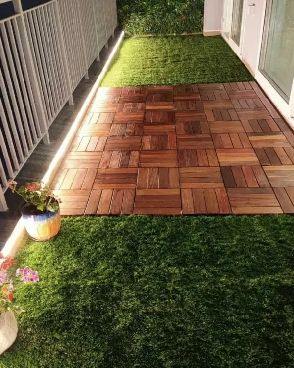 I turned this standard city balcony into a peaceful retreat. The design combines low-maintenance artificial grass with a central walkway of interlocking wooden deck tiles, all highlighted by subtle LED strip lighting for evening ambiance.