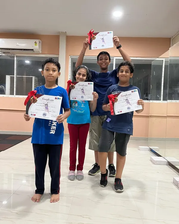 A group of my young students proudly holding their certificates after completing a dance course. It is rewarding to see them achieve their goals.