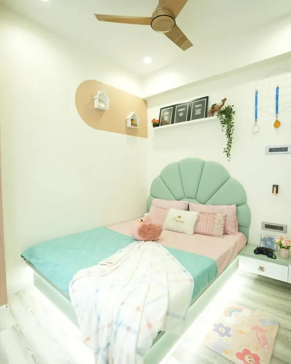 A dream room for a little princess. We designed this bedroom with a soft pastel color palette, a custom-made shell-shaped headboard, and whimsical details to create a magical and cozy space.