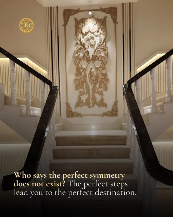 Who says perfect symmetry does not exist? This grand staircase with its marble steps, ornate wall molding, and balanced design leads you to the perfect destination in style.