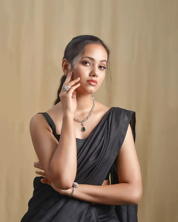 A model looking elegant in a simple black saree. I paired it with a modern sleeveless blouse, showing that sometimes simplicity is the ultimate sophistication.