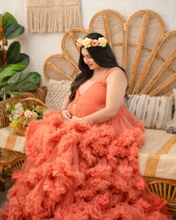 This voluminous peach tulle gown is a client favorite for a reason. Its layers of ruffles create a stunning, romantic silhouette that makes for truly breathtaking maternity portraits. Here it is styled with a delicate floral crown.