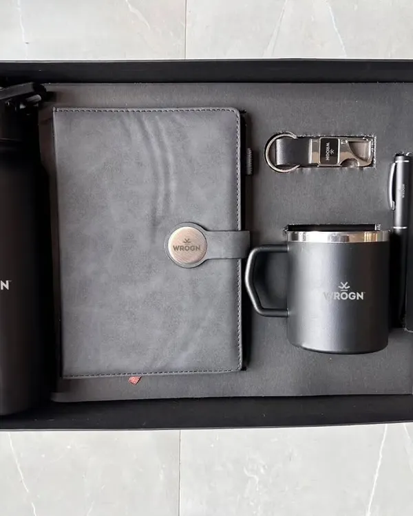 (Hero Item) This is the perfect example of a sleek and professional corporate gift set. The all-black theme for Wrogn, featuring a branded water bottle, diary, mug, pen, and keychain, shows a complete and cohesive welcome kit, all neatly arranged in a premium box.
