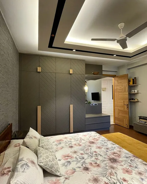 We designed this bedroom for a client who loves grey and warm wood. We added a dash of mustard in the bench and rug for a pop of color, creating a space that feels both moody and inviting.