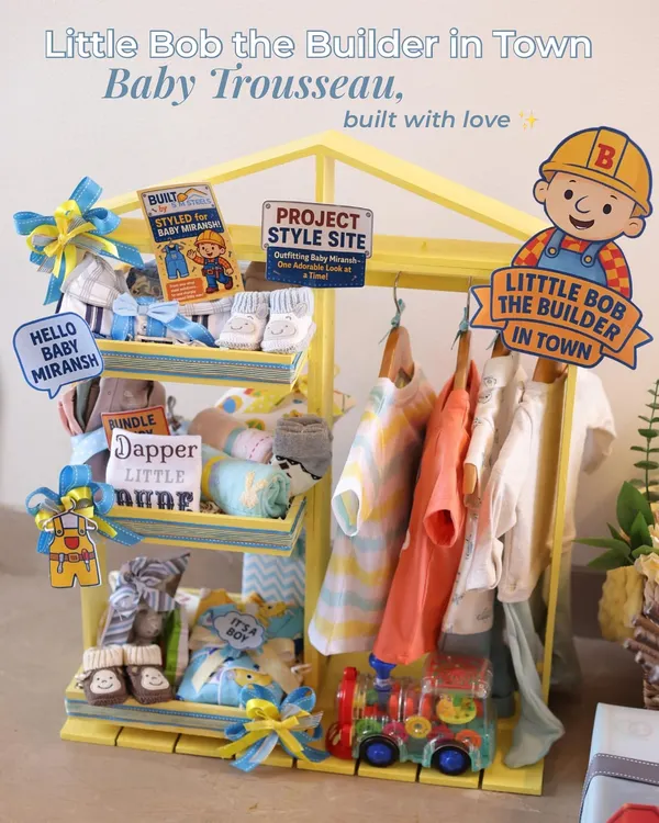 This 'Little Bob the Builder' baby trousseau is one of my favorite projects ever. I designed it for a family in the steel industry, creating a complete welcome set with a 'Style Site' wardrobe, a 'Storage Station' trunk, and a 'Steel Express' truck filled with goodies. It’s the perfect example of how I can turn your family's story into a magical gift.