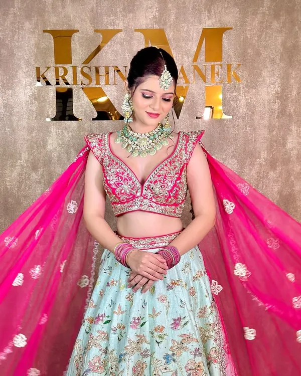 This client is ready for her sangeet in a modern pastel lehenga, paired with a rented mint green and polki necklace set.