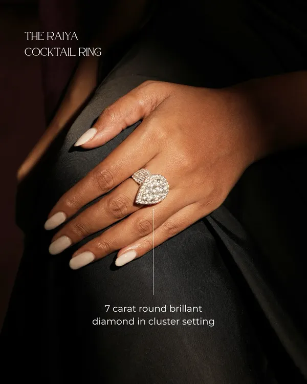 The Raiya Cocktail Ring, worn to showcase its impressive scale and brilliance. The 7-carat round brilliant diamond cluster is designed to steal every moment.