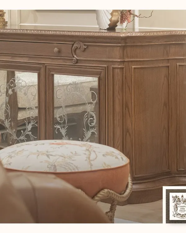 This wooden console is a perfect example of timeless sophistication. The piece features intricate carvings, a rich wood grain, and elegant mirrored doors with floral etching, bringing a sense of grandeur to any living space.