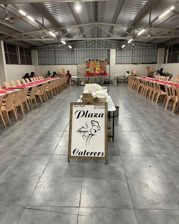 Our setup at RR Party Hall in Maddur, ready for the event to start. You can see our branded sign at the entrance, with the dining area neatly arranged in the background.