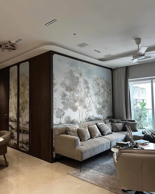 A panoramic landscape mural from Phillip Jeffries serves as the stunning focal point in this living room. The soft, painterly trees create a sense of depth and tranquility, seamlessly blending the interior with the expansive view outside.